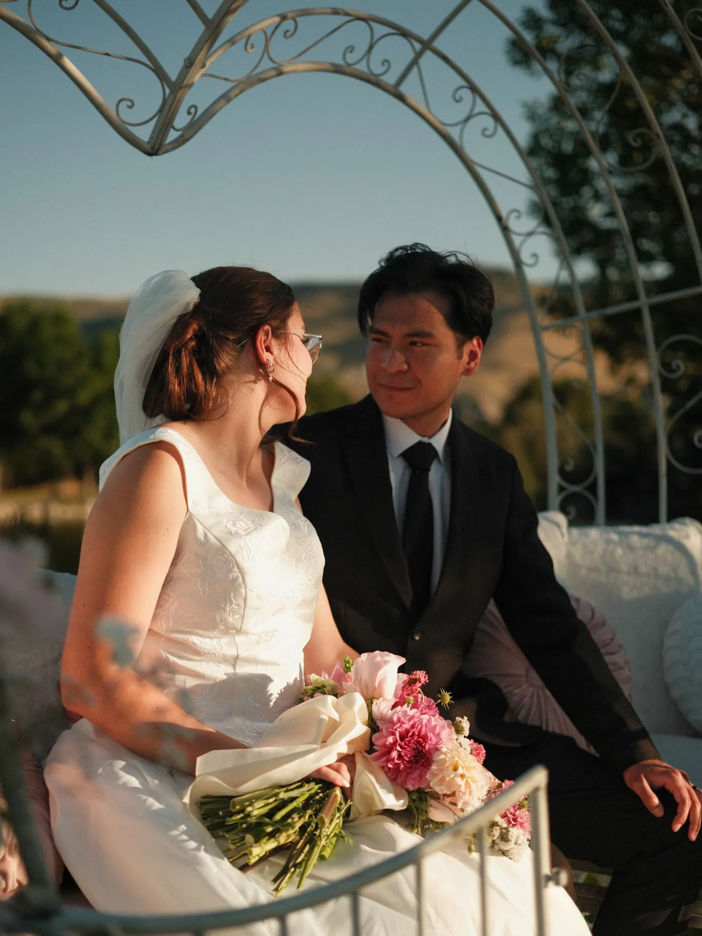 A couple seated in the EverGlow carriage at golden hour