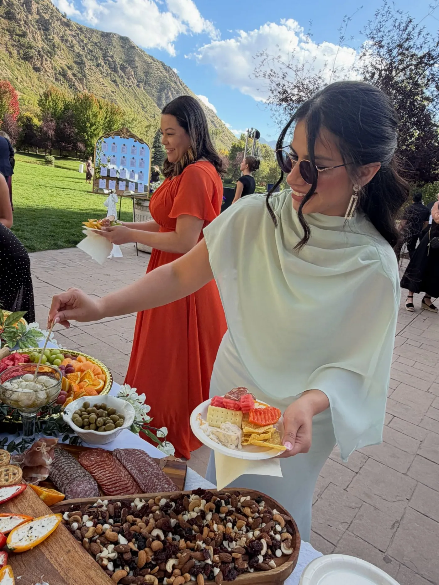 Guests serving themselves from an outdoor grazing table