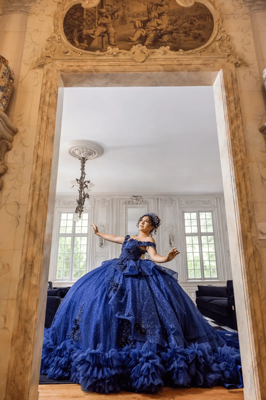A quinceañera in a blue gown at the campaign shoot