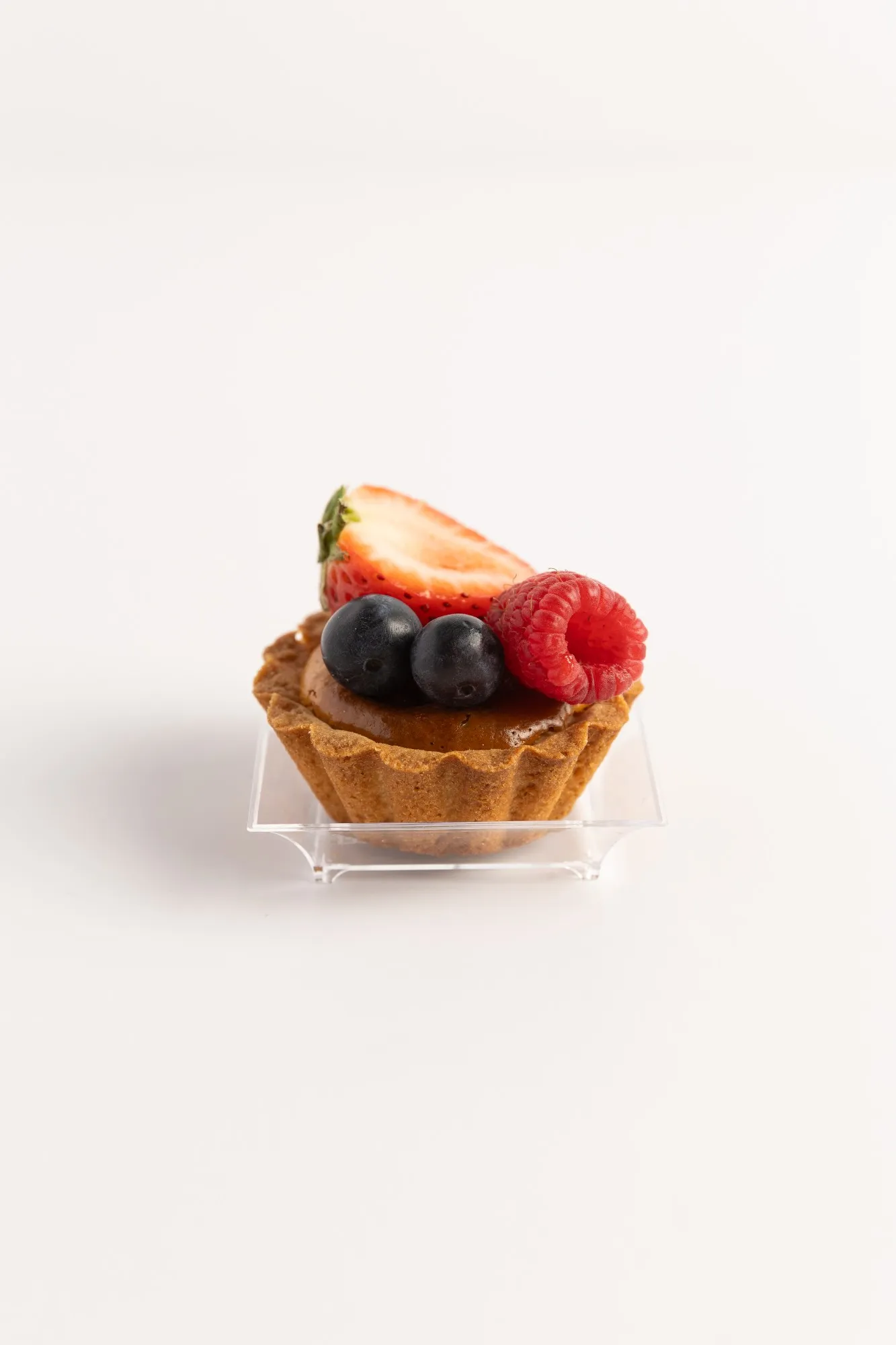 A mini fruit tart with berries