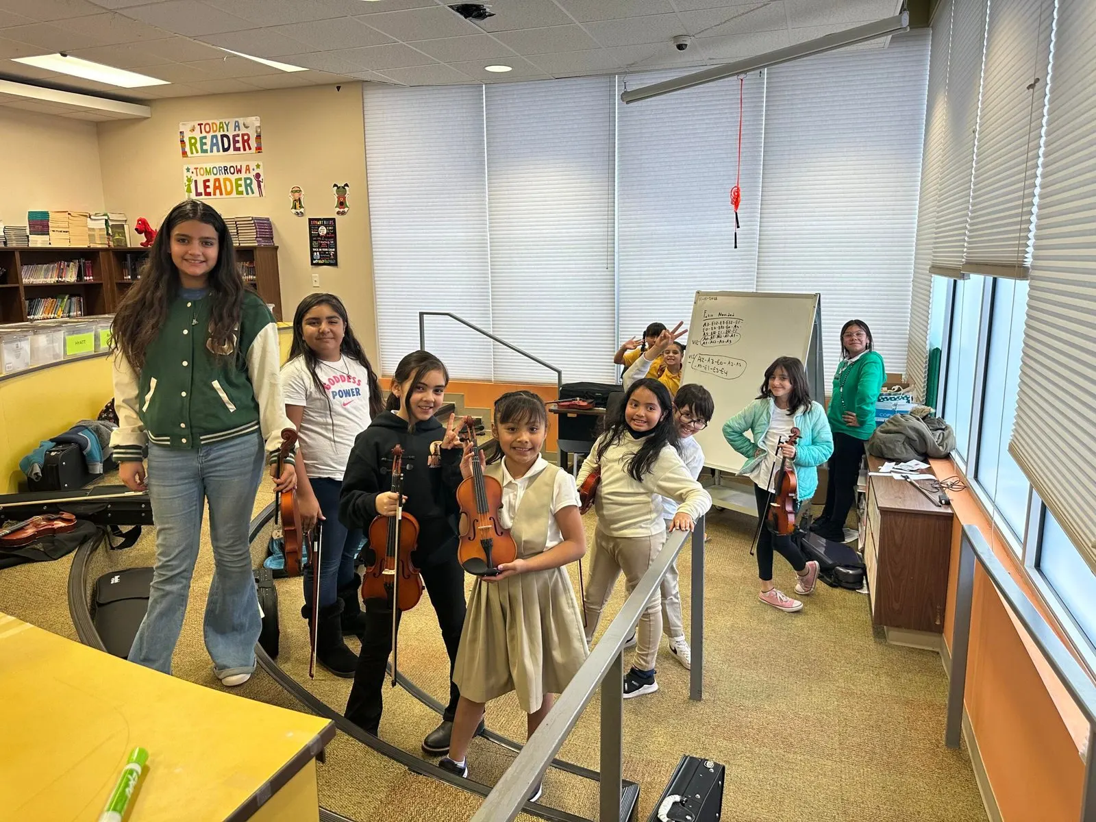 Young violin students with their teacher