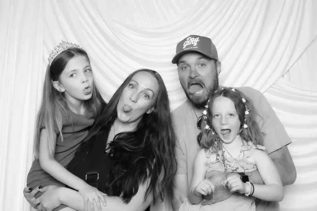 A family making silly faces in black and white