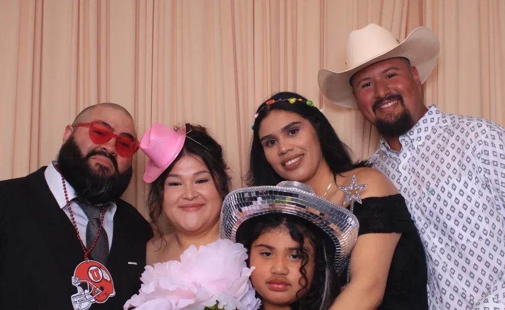 Quinceañera guests posing with props in the Proof Of Party booth