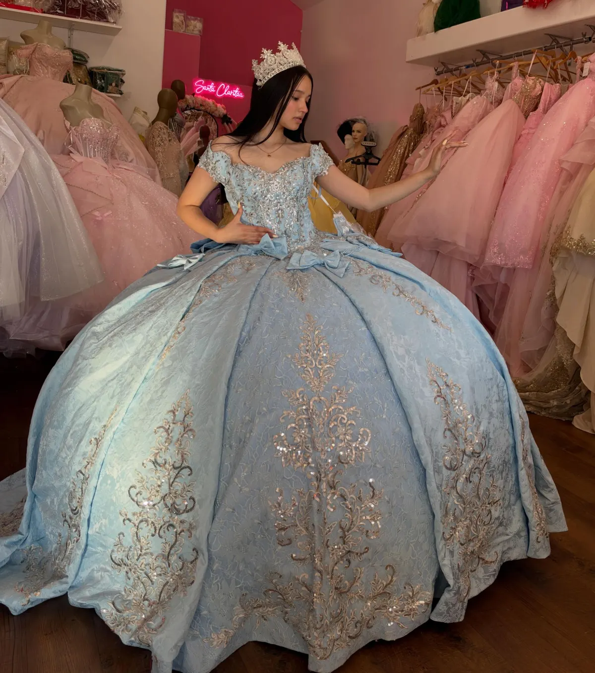 Trying on a brocade gown inside Santa Clarita Quinceañera Shop