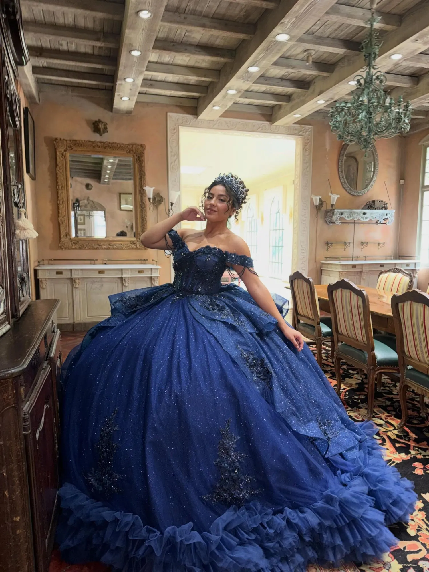 Quinceañera in a navy ball gown and crown from Santa Clarita Quinceañera Shop