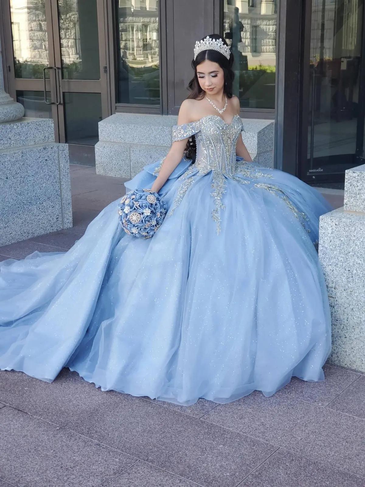 Quinceañera in sky blue seated at the Utah State Capitol