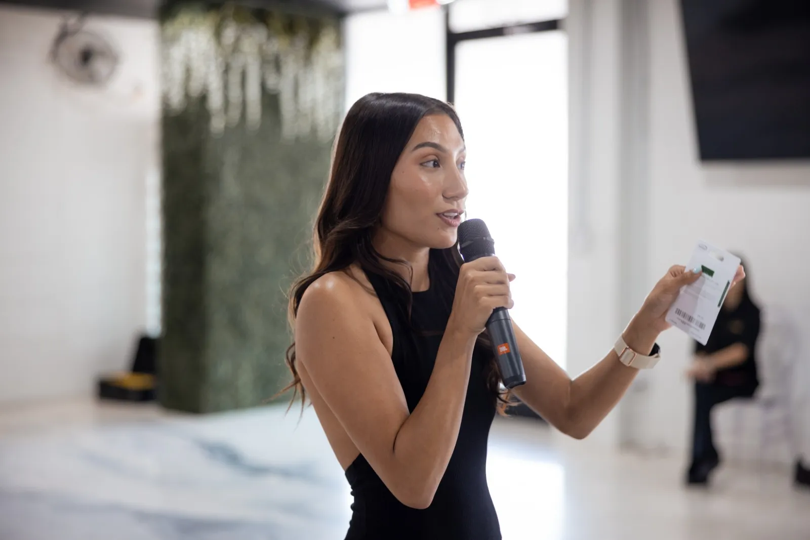 Emily speaking to a class with a microphone